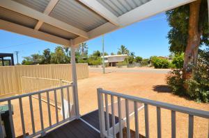 a porch with a fence and a basketball court at Surf Caster - Kalbarri, WA in Kalbarri