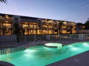 a swimming pool in front of a large building at Appartement La Tranche-sur-Mer, 2 pièces, 4 personnes - FR-1-194-221 in La Tranche-sur-Mer