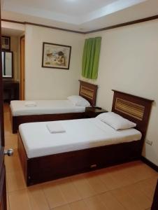 a room with two beds in a room at Darunday Manor in Tagbilaran City