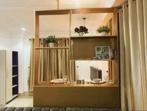 a dining room with a table and a mirror at Big Studio Unit in Lekki phase 1 - Kitchen, Washer, 24-7 light, WiFi & Netflix in Lagos