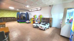 a room with toy cars and rides in it at GyeongJu Kids & Family Hotel in Gyeongju