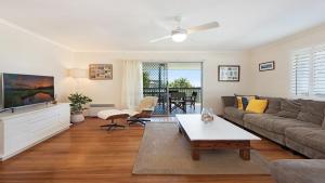 a living room with a couch and a table at 20 Mackay St Dicky Beach QLD in Caloundra