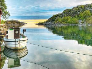 a boat is docked on a body of water at 5 person holiday home in lyngdal in Korshamn
