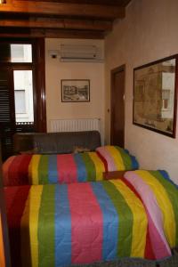 福賈的住宿－JLL Room，一张床上有五颜六色的毯子,放在房间里