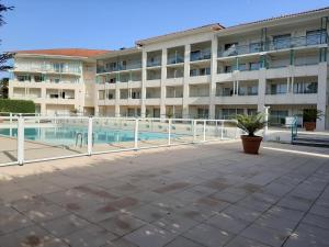 an apartment building with a pool in front of it at Appartement à Ciboure avec piscine chauffée et parking privé - FR-1-239-560 in Ciboure +11 photos