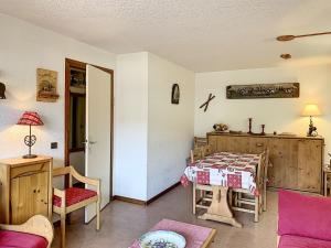 a living room with a bed and a table at Charmant 2 pièces au centre de Combloux avec balcon, parking et proche ski bus - FR-1-560-2 in Combloux +5 photos