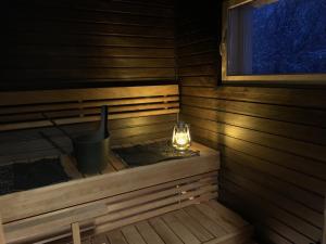 a sauna with a candle and a light in it at Riverside Home near Santa Claus Village - beautiful house in a prime location in Rovaniemi