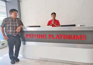 two men standing in front of a plotting station at an airport at Patong Platinums Phuket in Patong Beach
