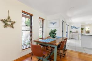 a dining room with a table and chairs at Little Whale House in Mudjimba