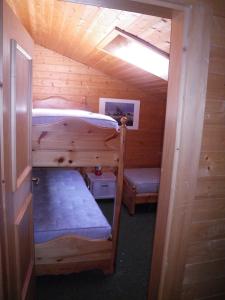 a room with two bunk beds in a cabin at Carezza Units, Dolomites in Carezza al Lago