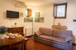 a living room with a couch and a table at City Center Apartments - Happy Rentals in Spello