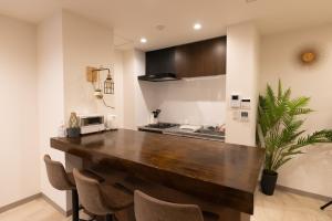 a kitchen with a large wooden counter in a room at Cinema Villa in Shushi