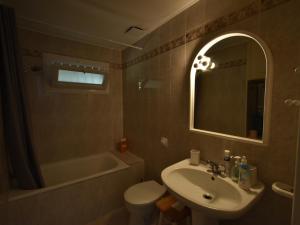 a bathroom with a sink and a toilet and a mirror at Maison de 4 chambres avec jardin à 150m de la plage - Pyla, La Teste-de-Buch - FR-1-420-94 in La Teste-de-Buch +18 photos