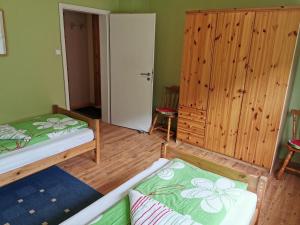 a bedroom with two beds and a closet at Haus Post EG-Wohnung in Todtnau