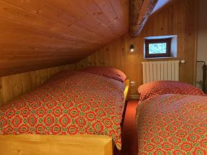 a bedroom with two beds in a wooden room at Chalet en Pierre 4 P. pour 6 Pers. à Méribel, Navette Gratuite et Grande Terrasse - FR-1-180-583 in Les Allues