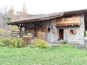 a stone house with a porch and a deck at Chalet en Pierre 4 P. pour 6 Pers. à Méribel, Navette Gratuite et Grande Terrasse - FR-1-180-583 in Les Allues