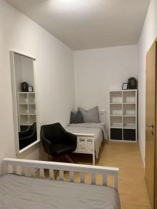1 dormitorio con cama, silla y espejo en EICstay - Ferienhaus für Monteure und Familie, en Worbis