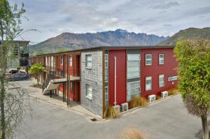 an overhead view of a row of buildings with mountains in the background at Lakeshore Studio at the Marina in Queenstown