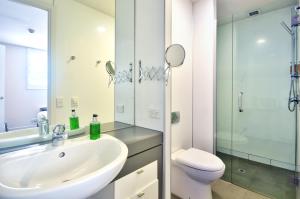 a bathroom with a sink and a toilet and a shower at Lakeshore Studio at the Marina in Queenstown