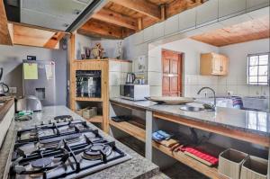 a kitchen with a stove and a counter top at Adventure Bush House II in Marloth Park