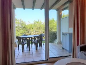 a sliding glass door leading to a patio with a table and chairs at Appartement Ciboure, 2 pièces, 4 personnes - FR-1-239-511 in Ciboure