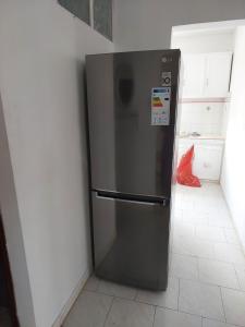 a stainless steel refrigerator in the corner of a kitchen at hamdan retreat villa in Grand Baie