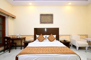 Ein Bett oder Betten in einem Zimmer der Unterkunft Aaram Baagh Maheshwar