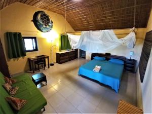 an aerial view of a bedroom with a bed and a couch at Moheli Laka Lodge in Mohéli
