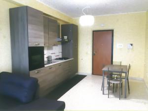 a kitchen and dining room with a table and chairs at Casa Airone in SantʼAlessio Siculo