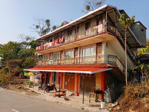 a building with balconies on the side of a street at Well Spring Homestay in Kalimpong