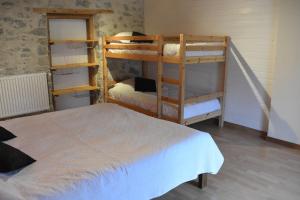 a bedroom with two bunk beds and a bed at Gîtes Tré Le Grenier in Les Moussières