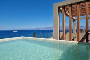 a swimming pool with a view of the ocean at Zeus Eleva Miraya in Agios Nikolaos