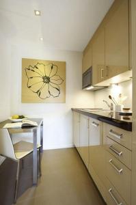a kitchen with a small table and a counter top at VISIONAPARTMENTS Cramerstrasse 8-12 - contactless check-in in Zürich