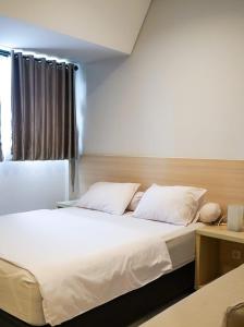 Postel nebo postele na pokoji v ubytování Mendjangan Residence