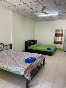 two beds in a room with green beds at Bangsaen Budget Hotel in Ban Samet