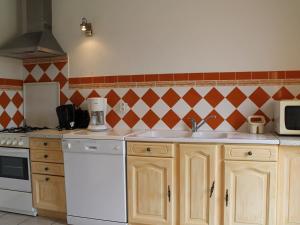 a kitchen with a sink and a microwave at Maison avec Jardin proche Thermes comprenant Lave-linge et Lave-vaisselle - FR-1-541-47 in La Roche-Posay +2 photos