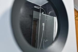 a mirror of a shower in a bathroom at Long Eaton Modern 4bed House in Long Eaton