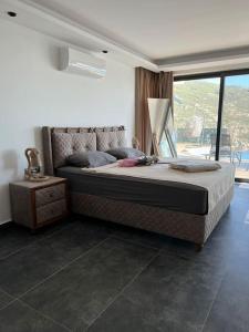 a bedroom with a large bed and a large window at Villa Vilara „Luxus Villa mit Traumaussicht“ in Kas