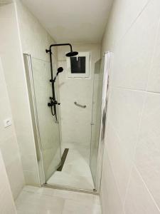 a shower with a glass door in a bathroom at AITA CASA BARBATE in Barbate +42 photos