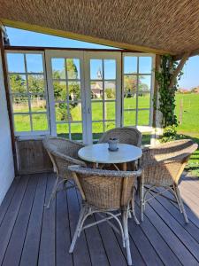 un patio con mesa y sillas en una terraza en 't Haringehuys en Poperinge