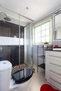 ein Bad mit einem WC und einer Glasdusche in der Unterkunft Home2Book Charming Sea Front House in El Escobonal