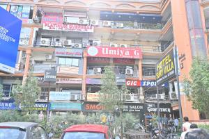 a busy city street with cars parked in front of a building at HOTEL SURY VILLA in Ahmedabad