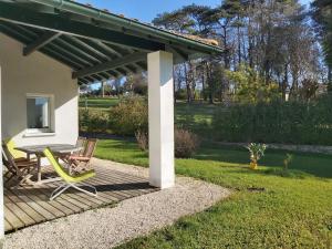 a patio with a table and chairs on a deck at Appartement Ascain, 3 pièces, 4 personnes - FR-1-239-504 in Ascain