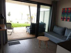 a living room with a couch and a table at Appartement La Tranche-sur-Mer, 2 pièces, 4 personnes - FR-1-194-218 in La Tranche-sur-Mer