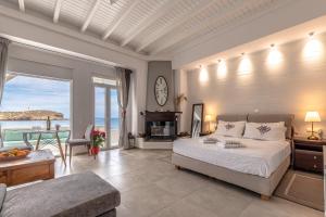 a bedroom with a bed and a living room with a table at Grotta Sognare in Naxos Chora