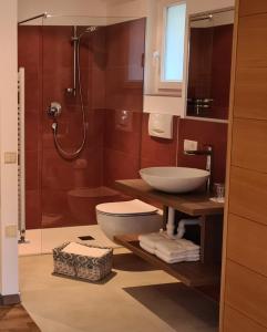 a bathroom with a sink and a toilet and a shower at Appartements Dornach in Schenna +55 photos