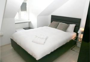 a bedroom with a large bed with white sheets and pillows at VISIONAPARTMENTS Cramerstrasse 8-12 - contactless check-in in Zürich