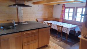 a kitchen with a table and a dining room with a table at Schwarzwaldstube in Titisee-Neustadt