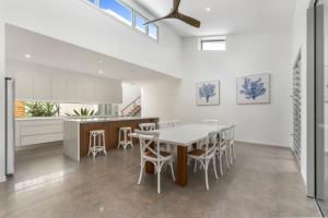 a kitchen and dining room with a table and chairs at Key Ct 10 in Noosa Heads