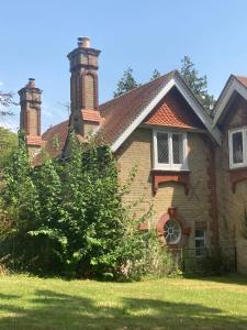 a house with two chimneys on top of a yard at 3 The Mews in Ryde